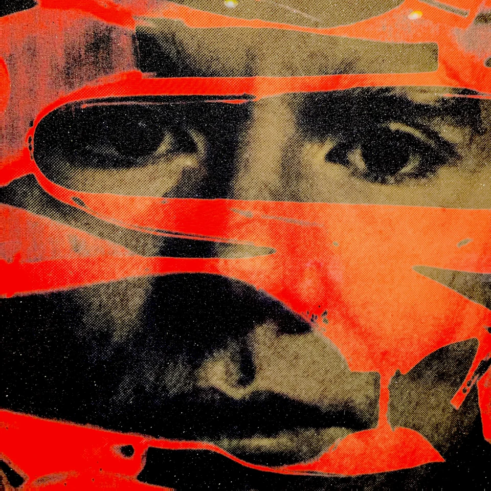A face crossed by bright red and black painted forms.