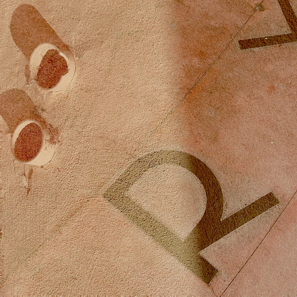 Large lettering layered with circles and pale peach textures.